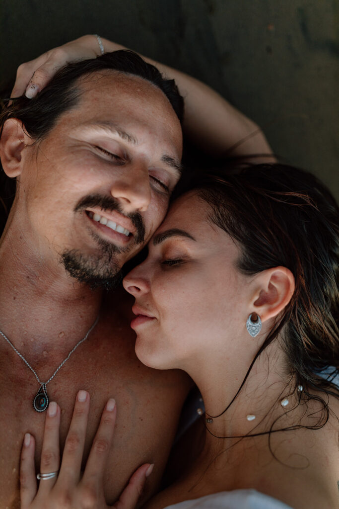 couple laying on costa rica beach for beach couples session