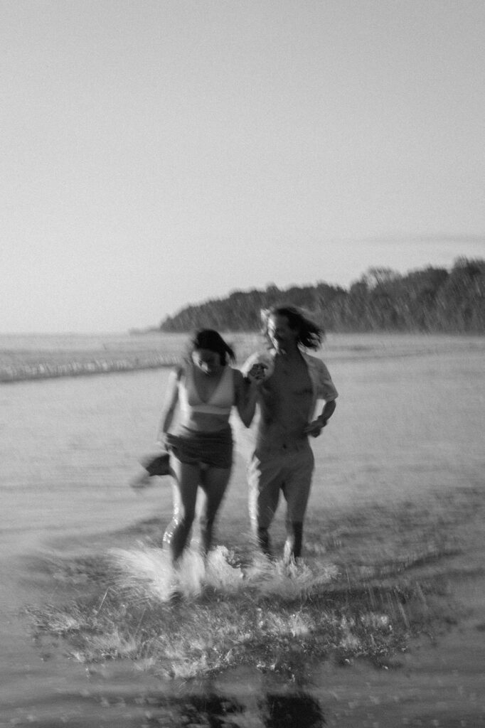 blurry candid couple photos running on the beach