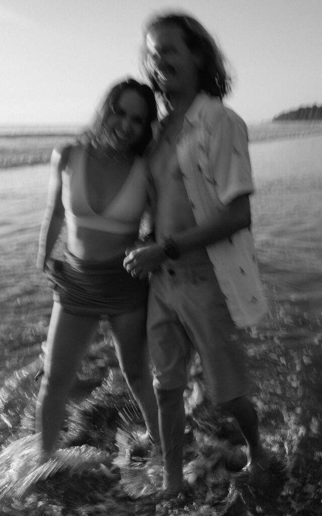 blurry candid couple photos running on the beach