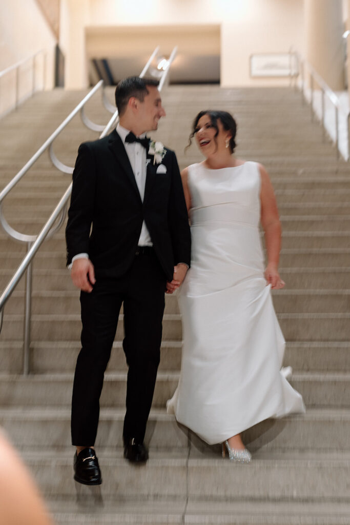 bride and groom walking down stairs after ceremony