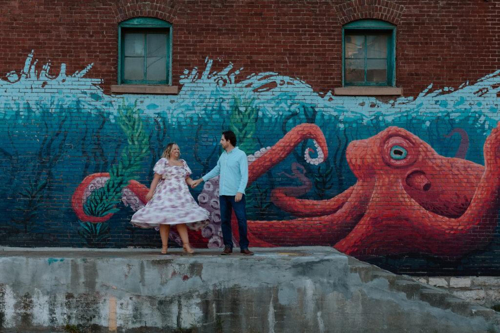 couple standing in front of Kansas City mural west bottoms