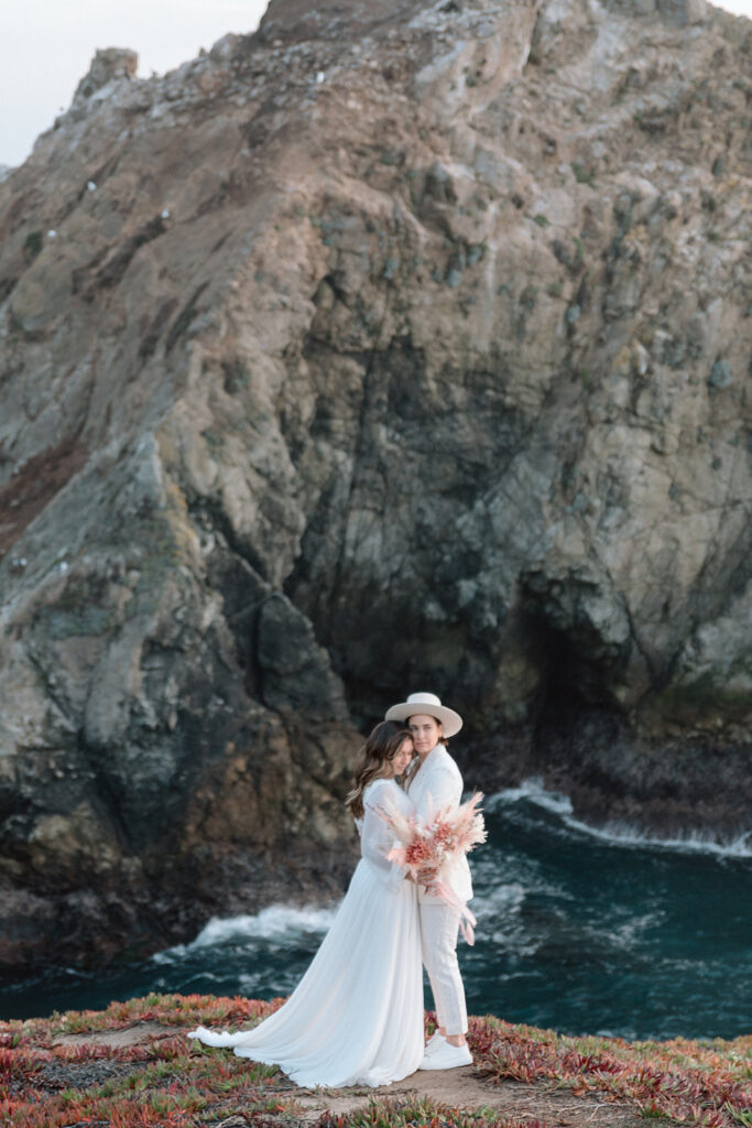 couple standing in front of big sur cliffs