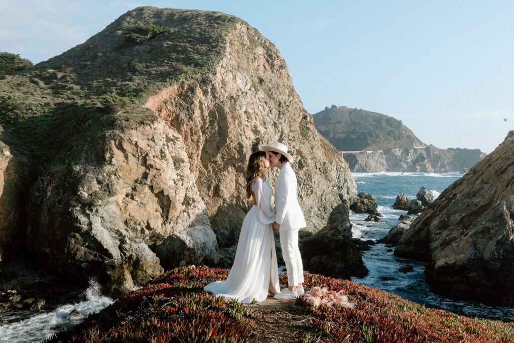 couple standing on cliffs in california beaches