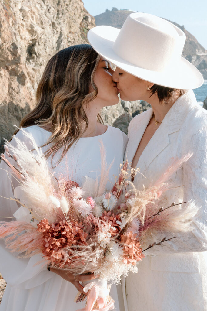 lgbtq elopement couple kissing boho bridal bouquet