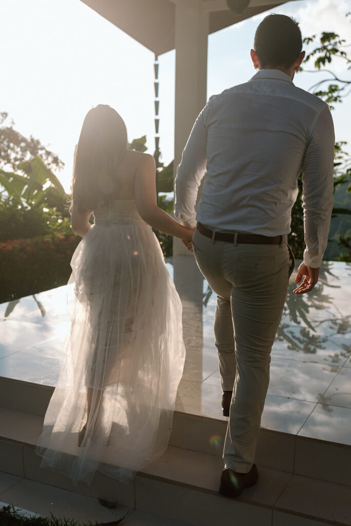 bride and groom walking in golden pineapple villas costa rica