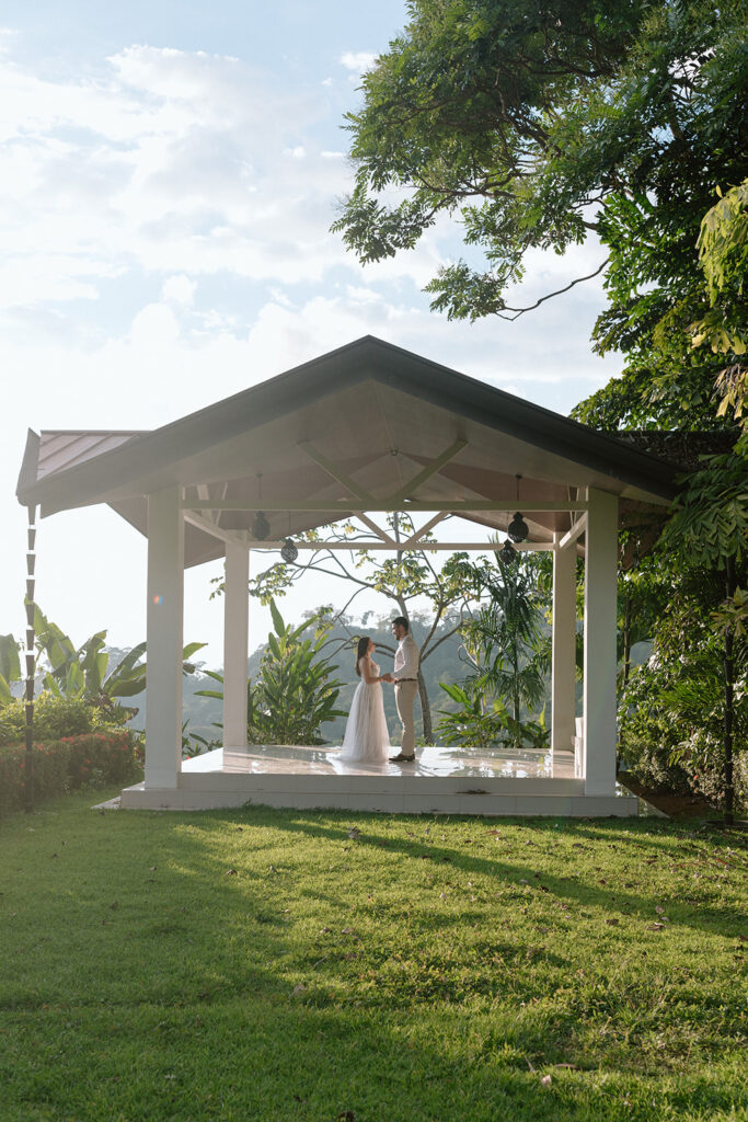 bride and groom standing in gazebo in costa rica