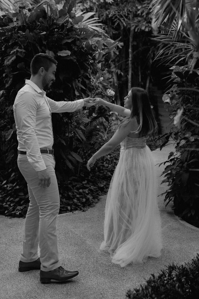 bride and groom spinning candid poses in the jungle