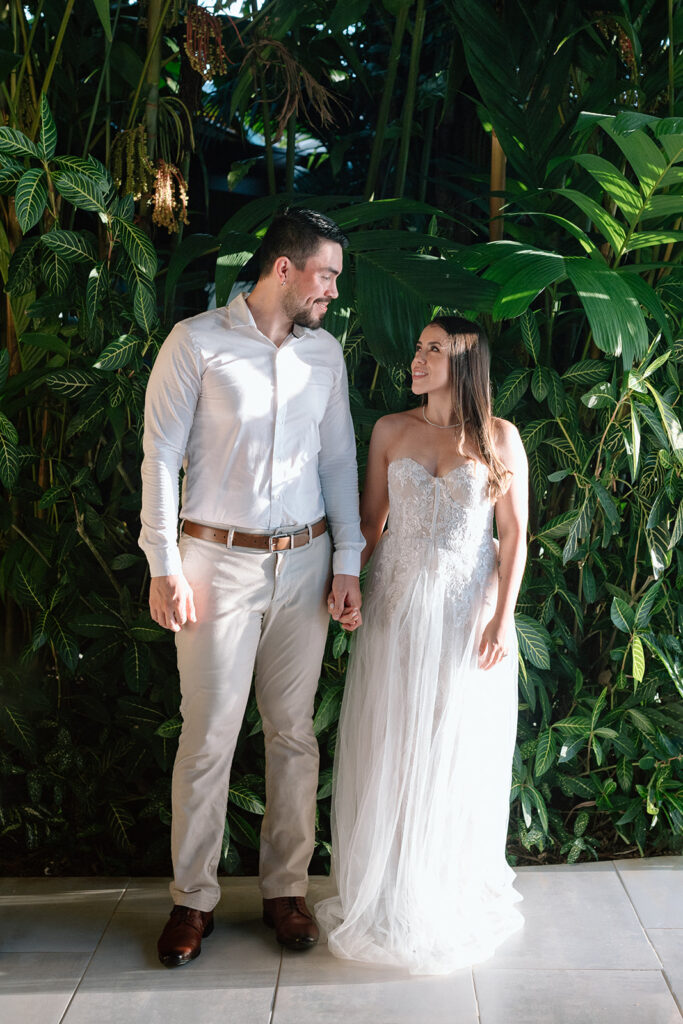 couple holding hands and smiling at each other in the costa rica jungle