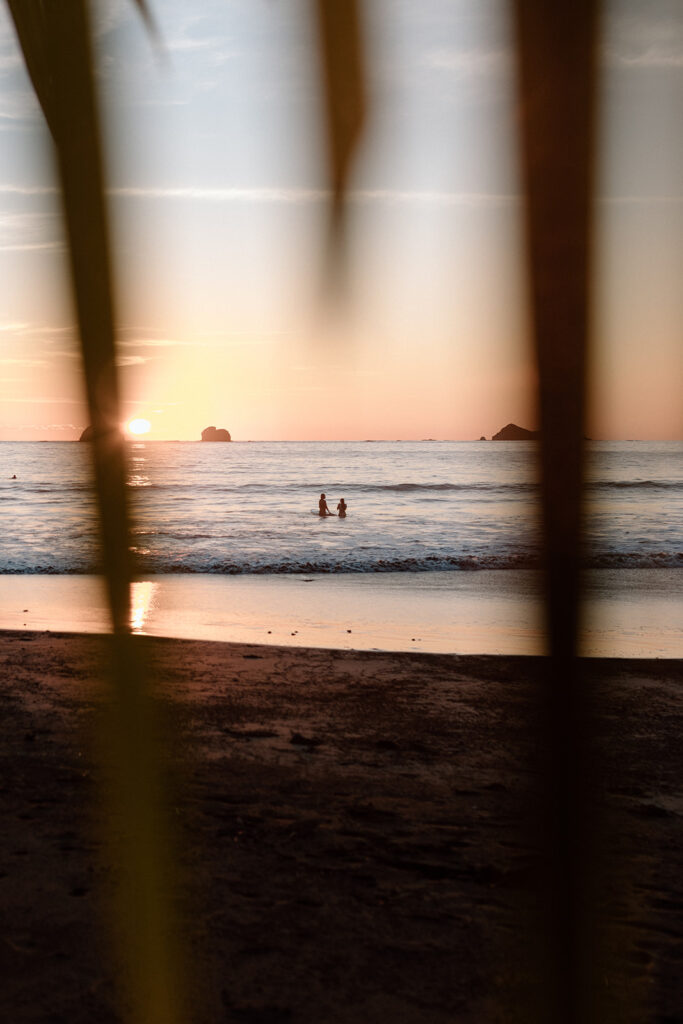 couple surfing during sunset