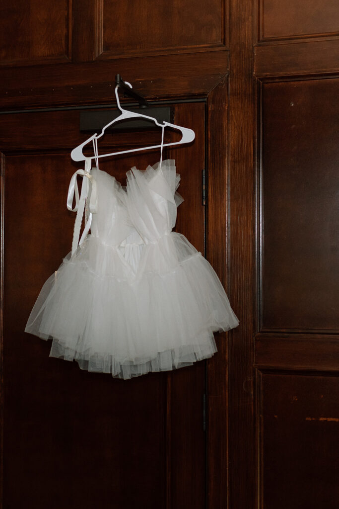 engagement dress hanging on hanger in hotel