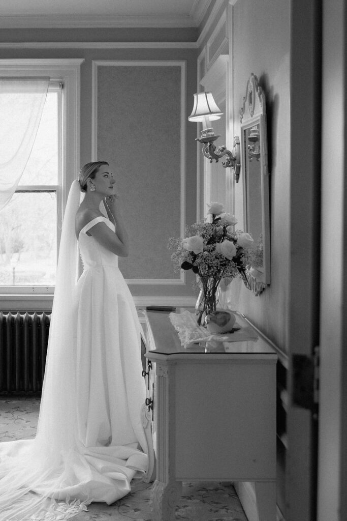 The model bride getting ready in the bridal suite at Longview Mansion in Lee's Summit.