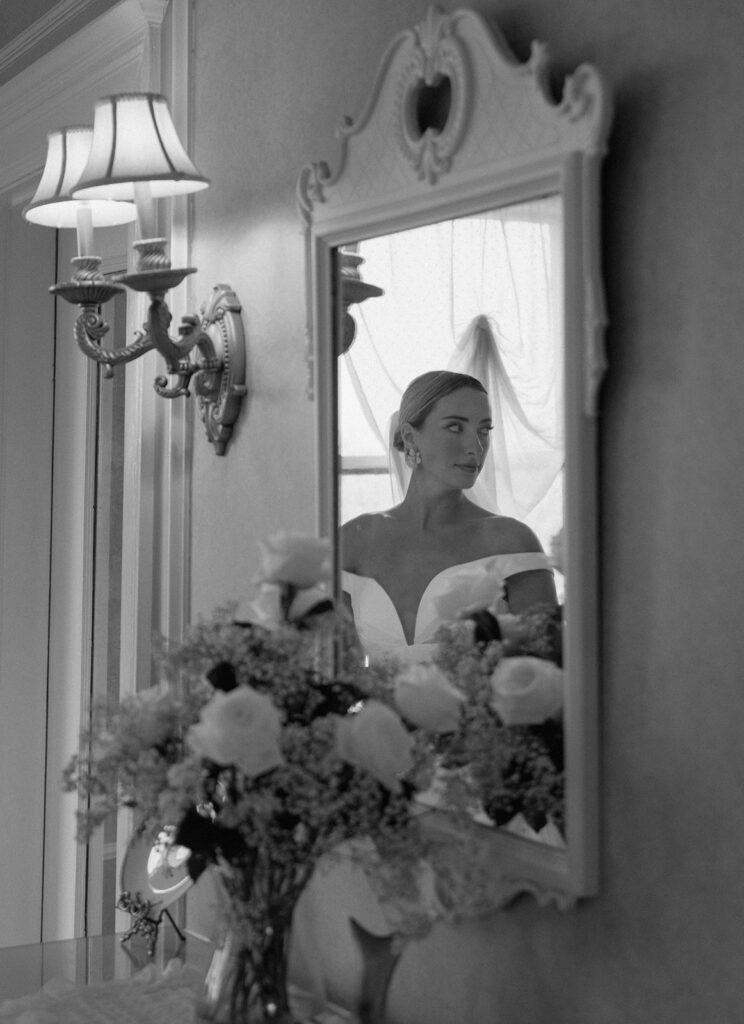 The model bride gets ready in the bridal suite at Longview Mansion for her wedding portraits.