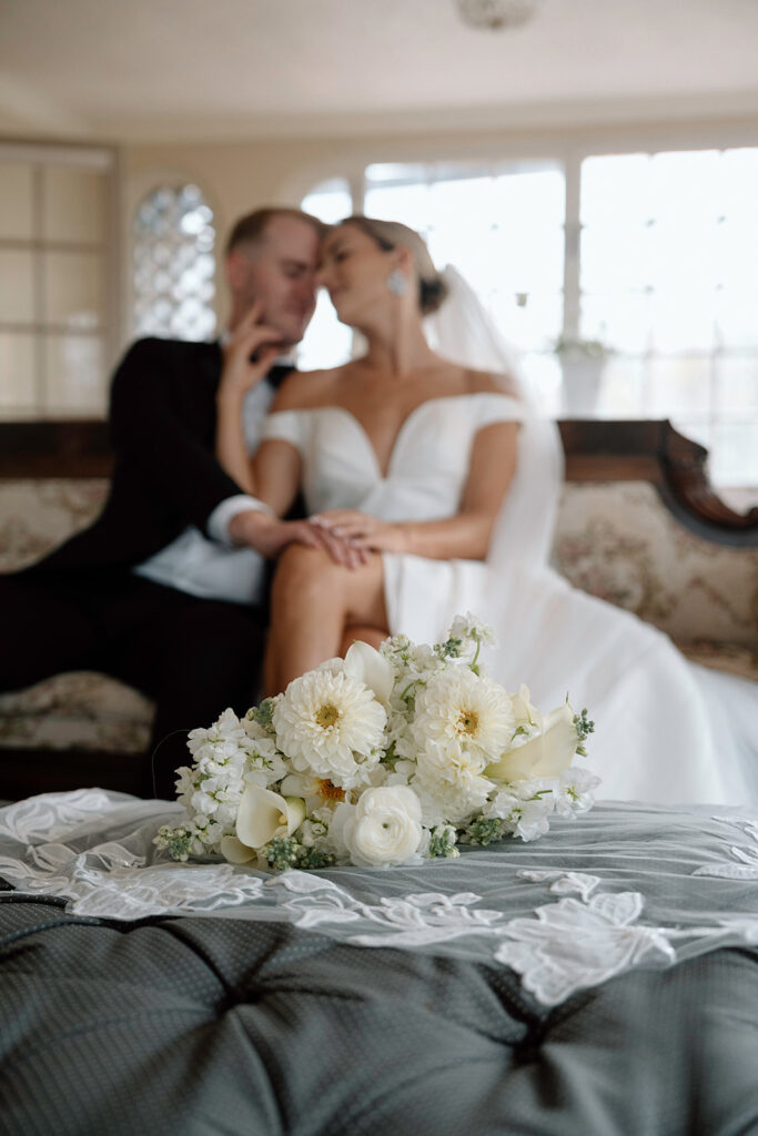 A romantic wedding picture featuring elegant white and green wedding florals.
