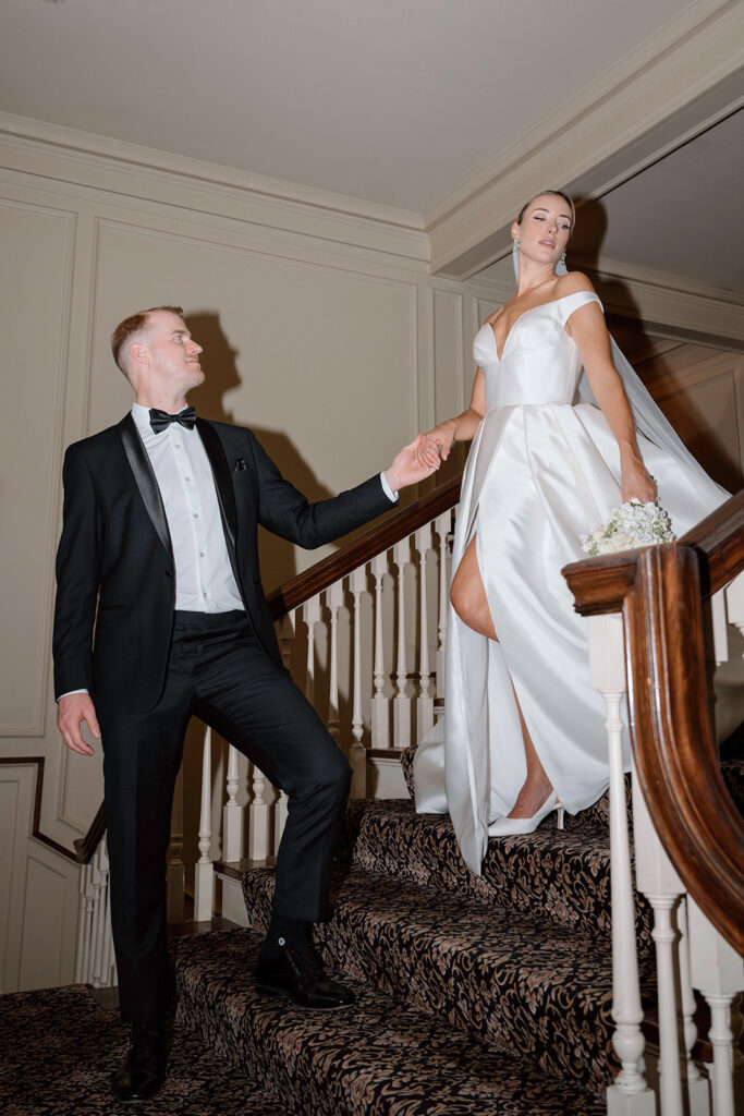 An editorial wedding picture taken on the grand staircase at the Longview Mansion wedding venue.