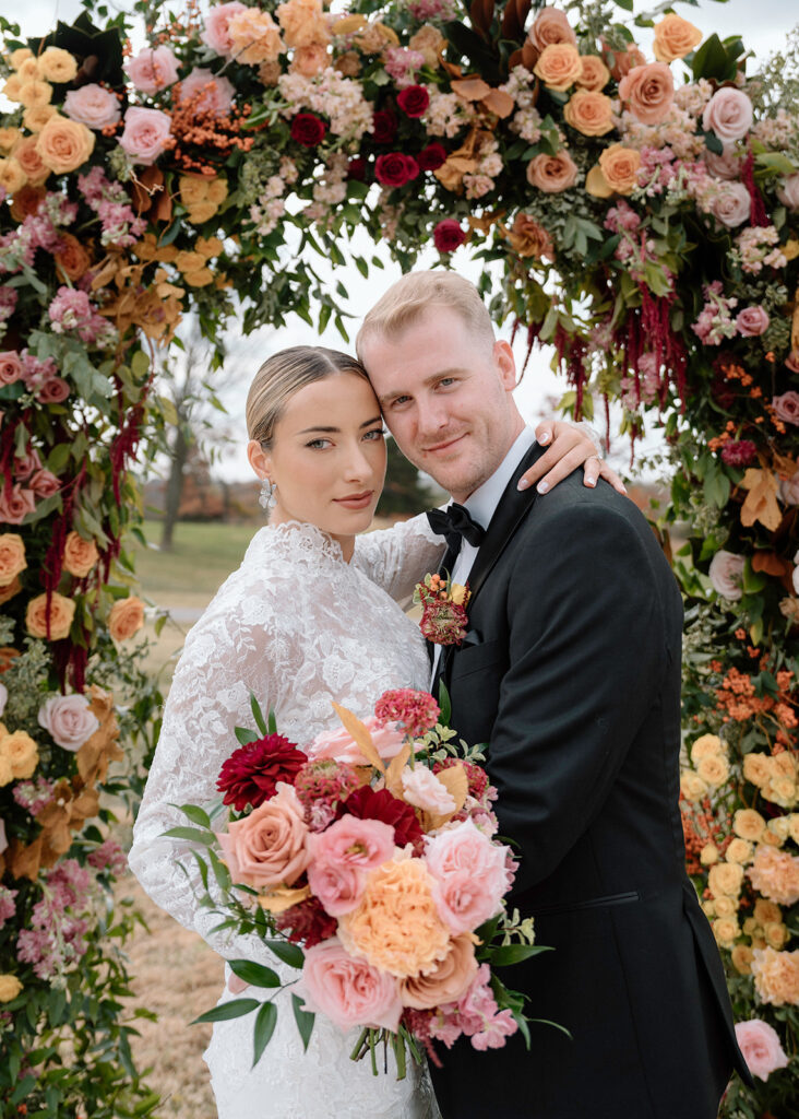 Taylor and Reece posing for a wedding picture in the Historic Sunken Garden ceremony spot at Longview Mansion in Kansas City.