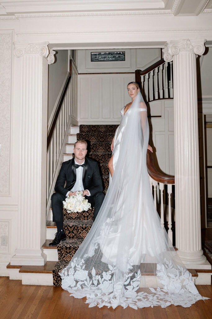 The models for the styled Longview Mansion wedding photoshoot posed for a flash photo on the staircase.