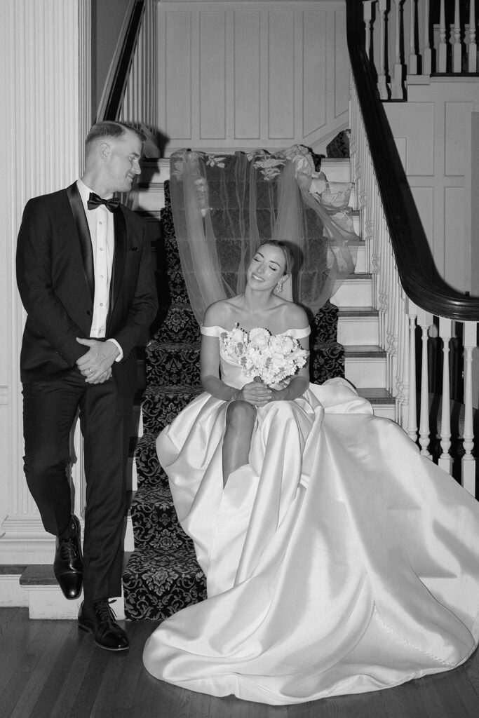A black and white image image from a styled wedding at Longview Mansion with a boutique wedding gown and a Floriography KC elegant bouqet.