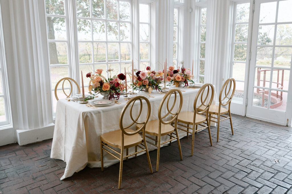 A luxury tablescape designed for the reception by Kansas City wedding vendors, such as The Perfect Touch KC, Floriography KC, and Quest Events, in the Longview Mansion dining room.