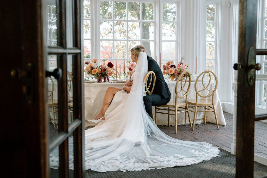 An intimate wedding picture of couple at the head table in during the styled ception at Longview Mansion.