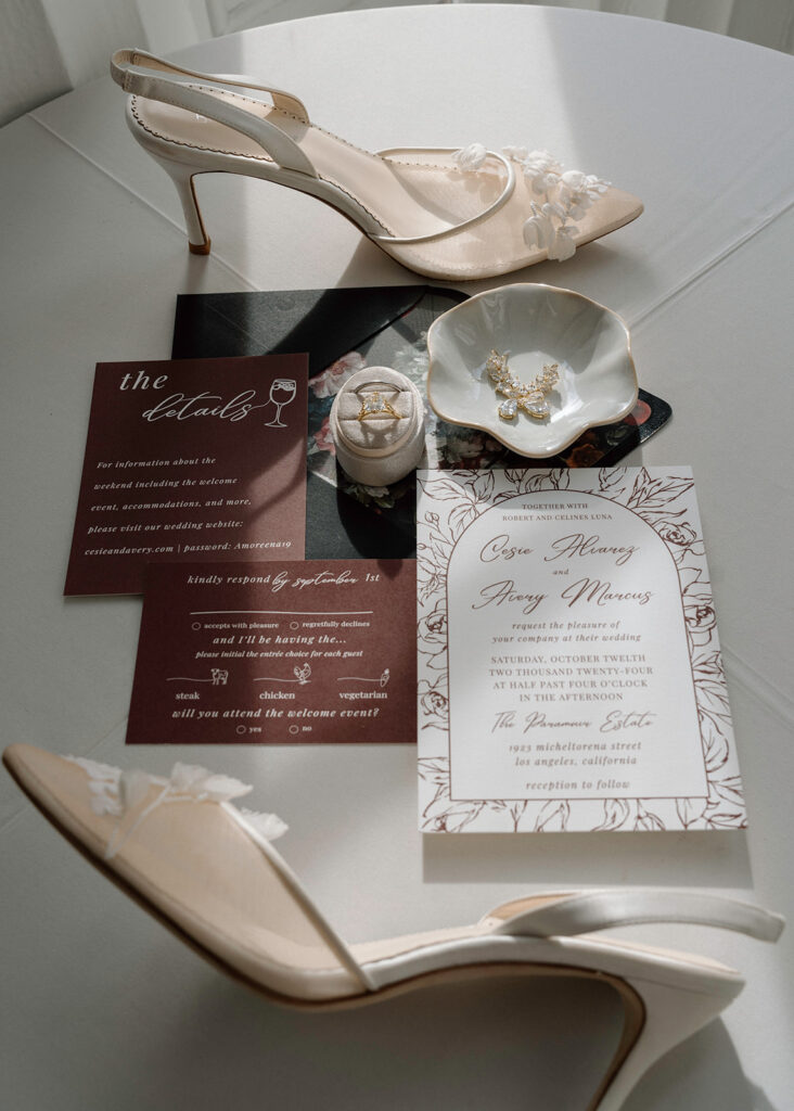 A flatlay in the pavilion at Longview Mansion with The Suite Studio invitations and Bella Belle shoes.