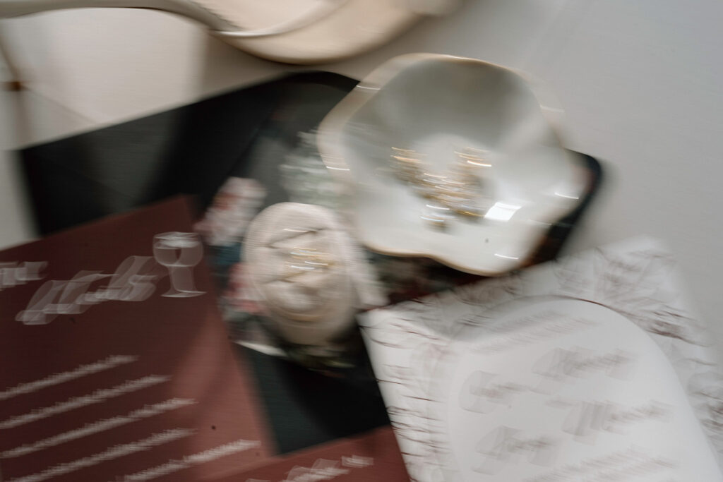 An artistic, blurry wedding photo of the luxury invitation suite.