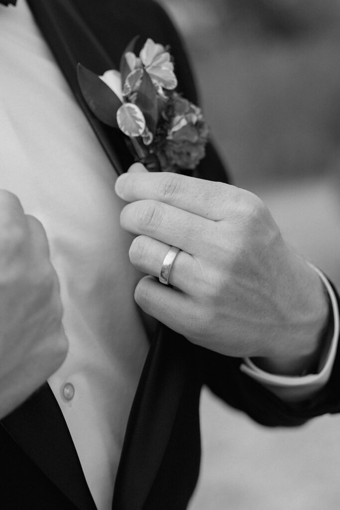 The groom's wedding ring as he straightens his suit jacket for wedding photos at Longview Mansion.