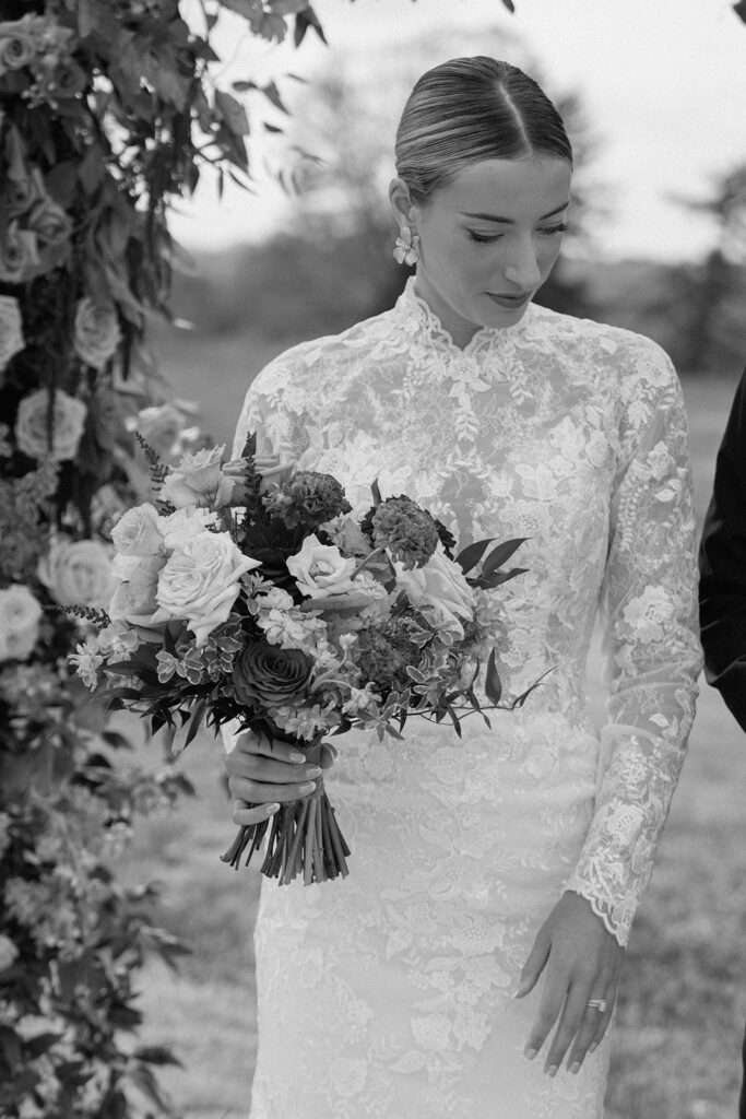 A candid wedding picture of bride with her luxury bouquet as she takes pictures for a styled wedding.