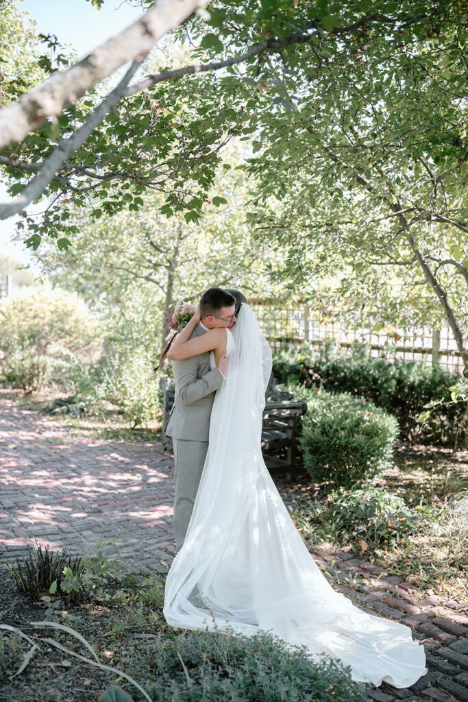 bride and groom first look in the garden at Gather at Red Cedar Gardens