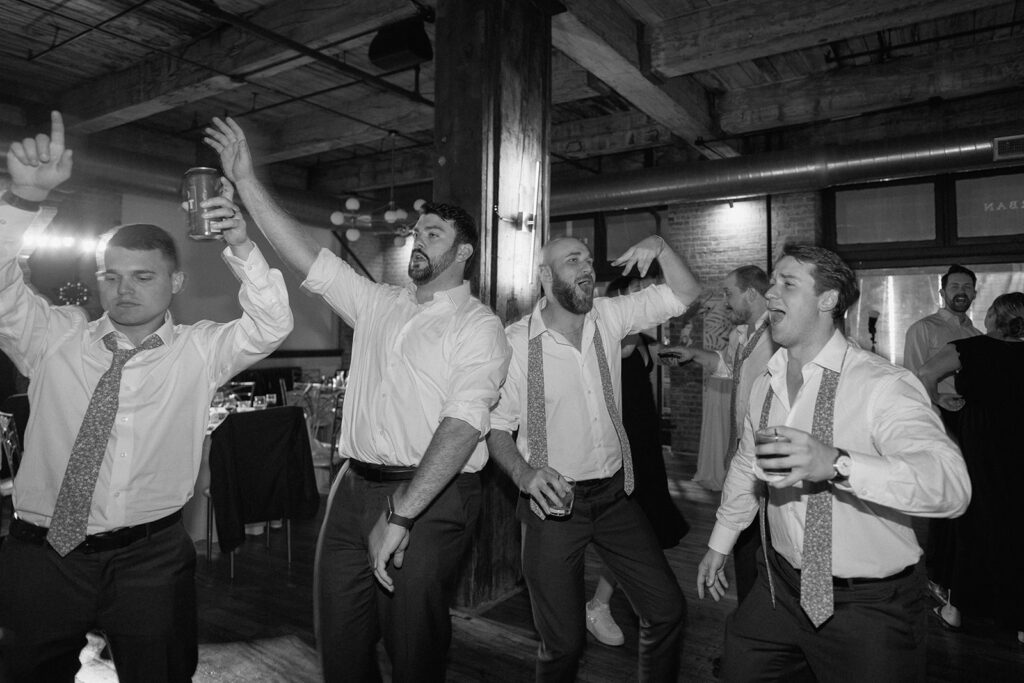 groomsmen dancing during the reception in the West Bottoms