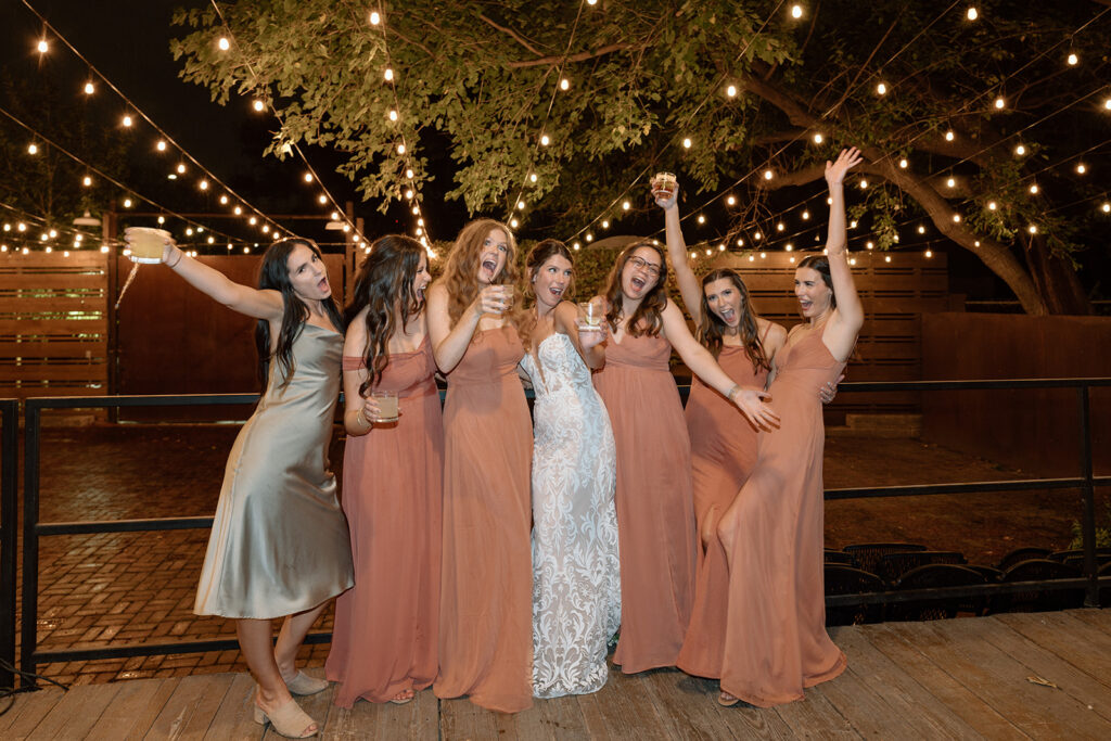 bride and bridesmaids pose for a photos in the courtyard wedding venue
