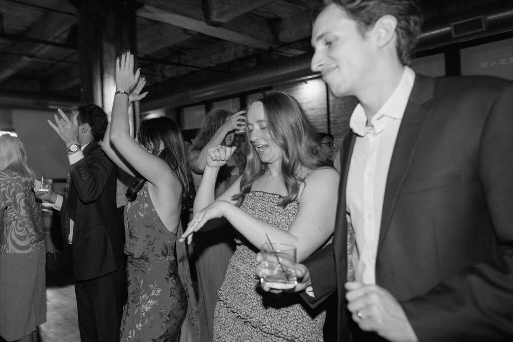 documentary style wedding photography of guests dancing in Kansas City