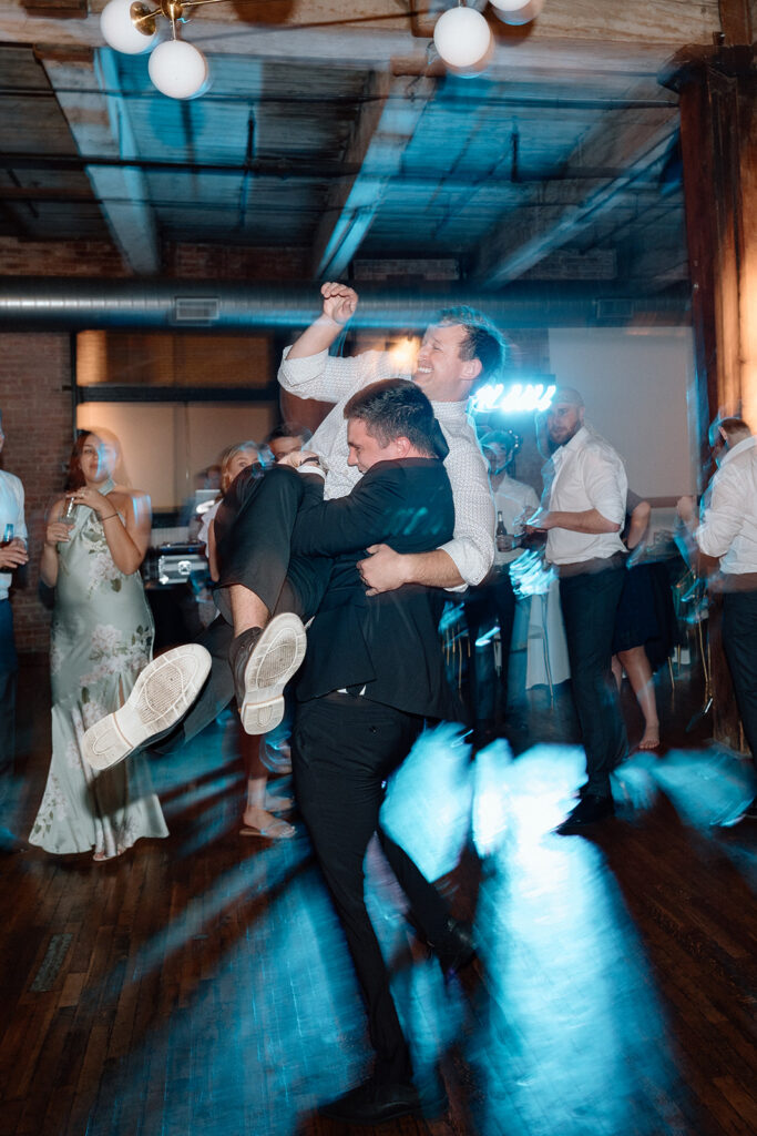 documentary style wedding photos of guests dancing in Kansas City
