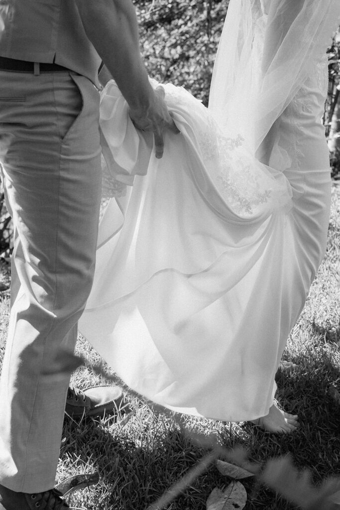 The groom helping the bride, as presented with documentary style wedding photography