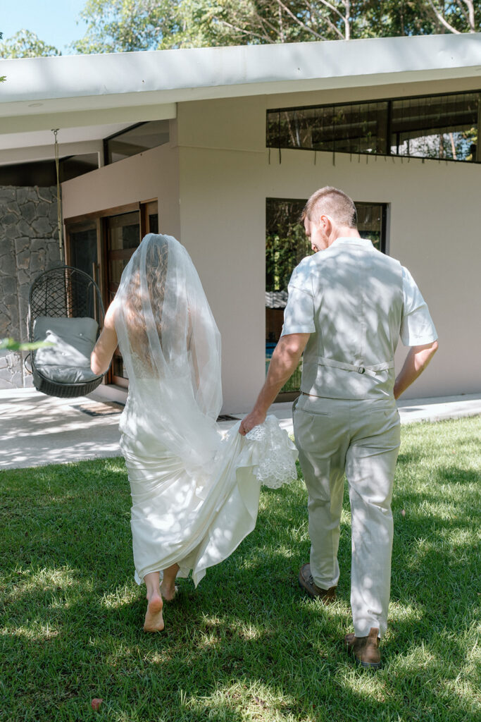 The groom helping the bride, as presented with documentary style wedding photography