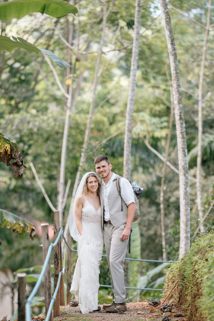 Bride and groom posed photo during the hike to the waterfall elopement ceremony.