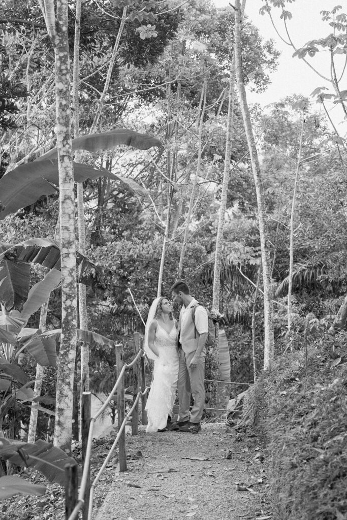 Bride and groom posed photo during the hike to the waterfall elopement ceremony.