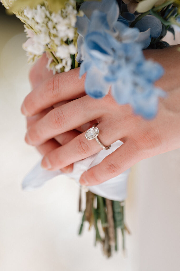 Ring shot holding the bouquet.