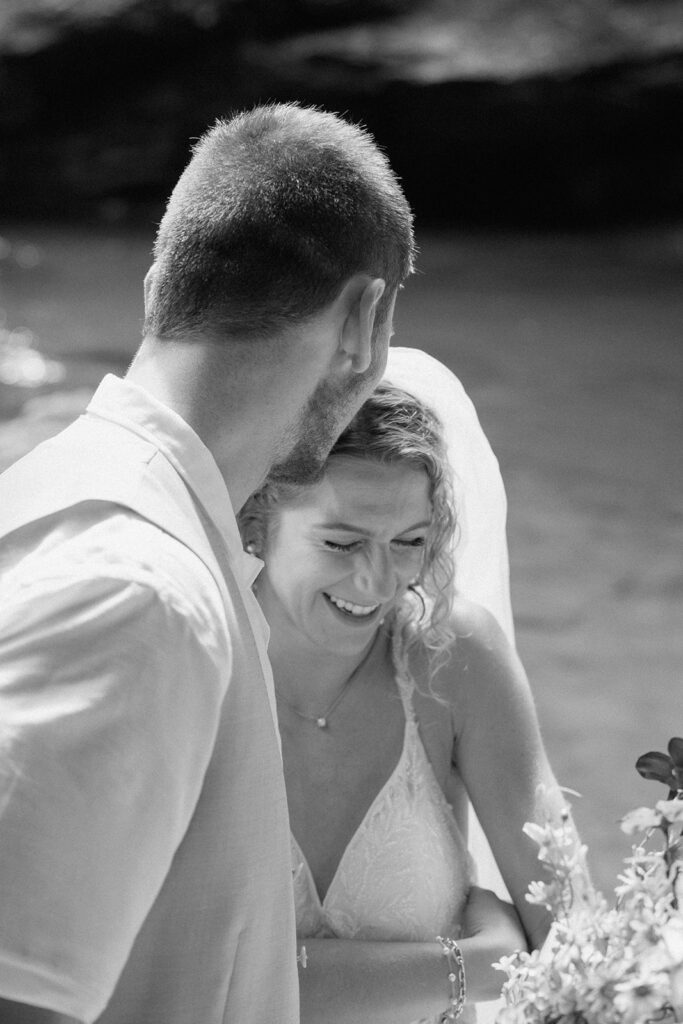Bride and groom celebrating after eloping at Nauyaca Waterfalls.