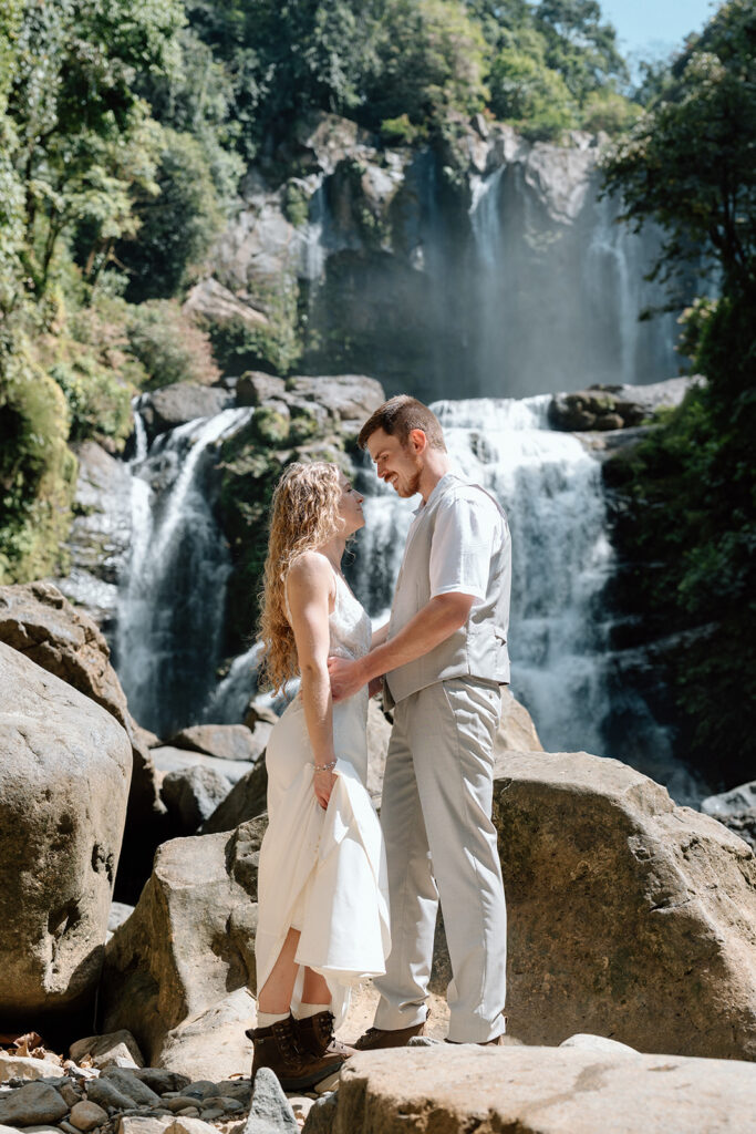 Staci and Cole exploring the waterfall for adventurous wedding pictures.