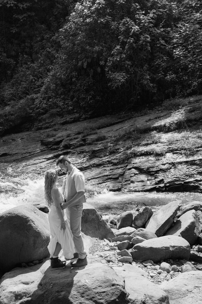 Staci and Cole exploring the waterfall for adventurous wedding pictures.