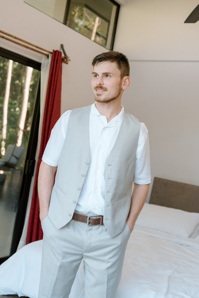 The groom getting ready before eloping at Nauyaca waterfall.