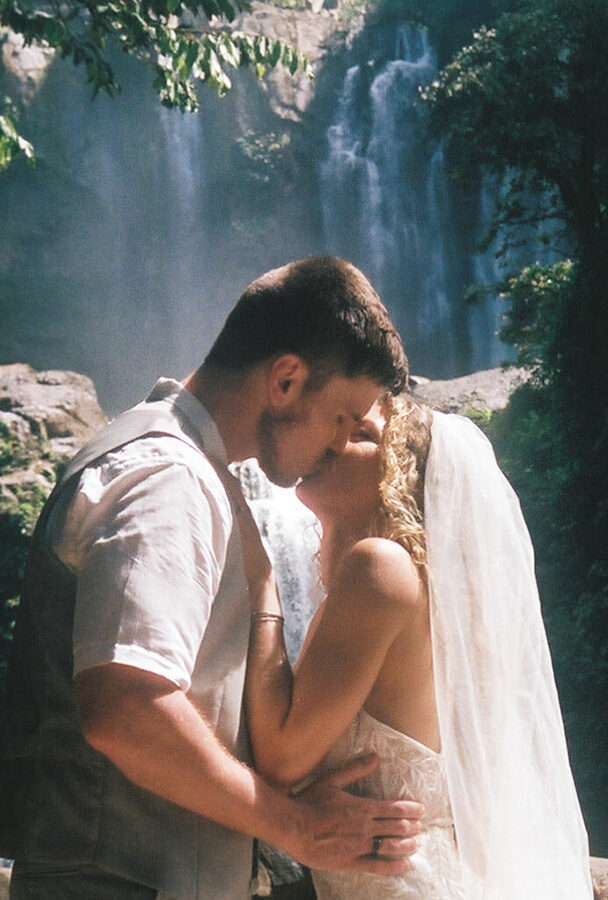 picture of the first kiss on 35mm film of a couple eloping at Nauyaca Waterfalls 